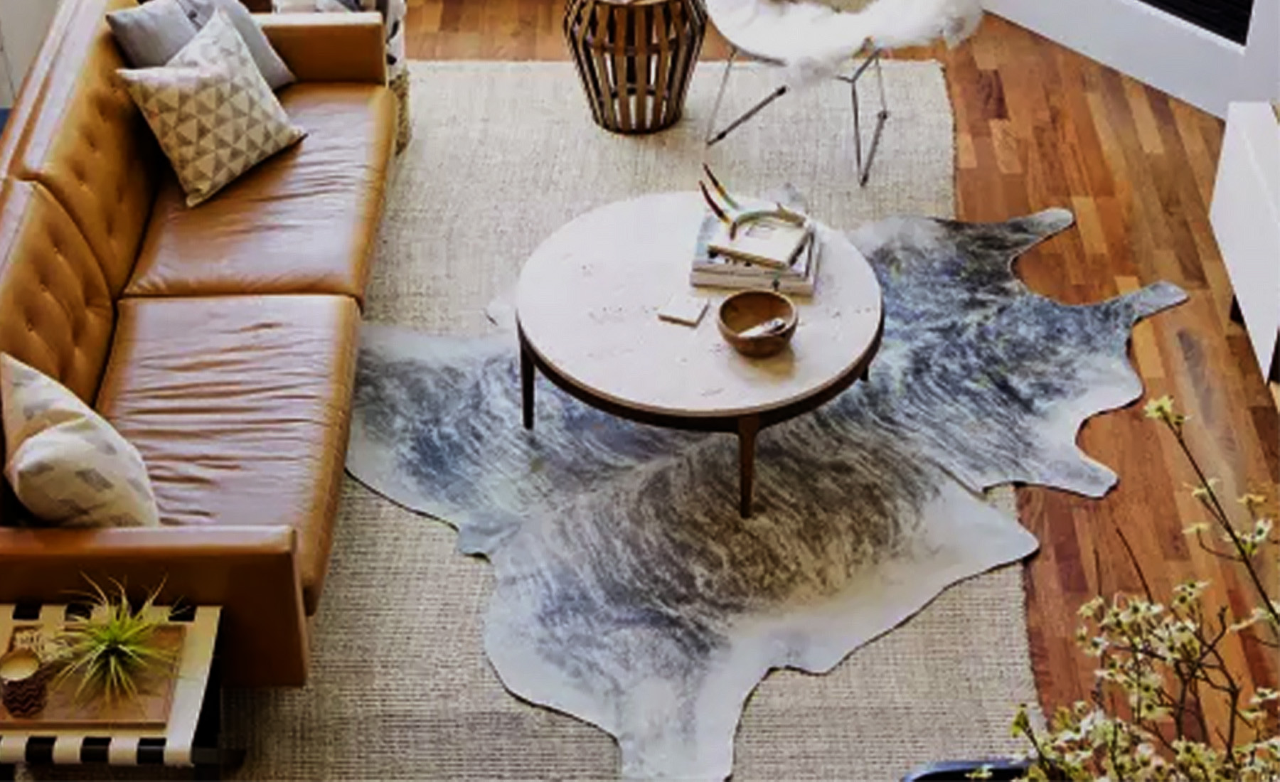 Play with Scale: Use rugs of different scales to create visual contrast. For instance, you can layer a large bottom rug to anchor the scheme and then layer vintage Persians or sheepskins on top.